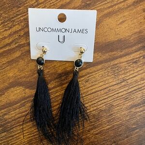 Uncommon James black earrings pierced